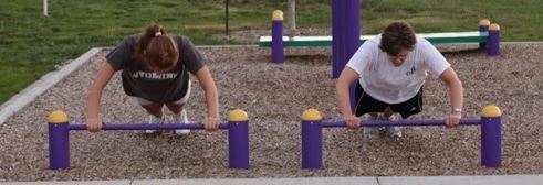 Two People Using Push-Up Bars